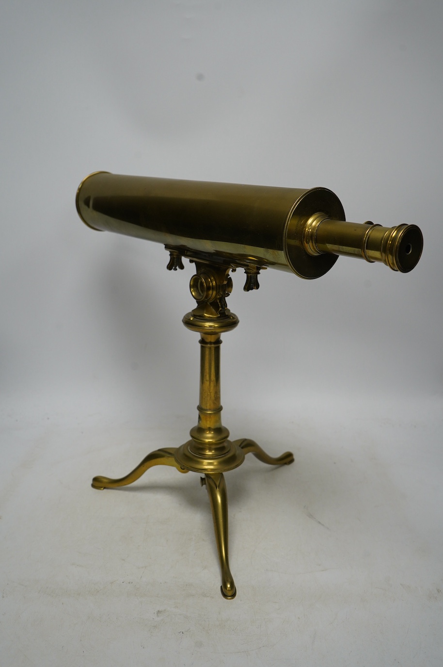 A portable brass reflector telescope on a tripod stand, engraved Ayscough, 44.5cm long. Condition - fair